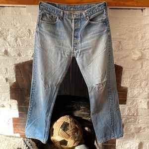 Vintage Levi’s 501 button fly jeans, rip on left thigh. Actual size 32x30
